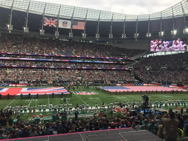 Flags on field as US national anthem being sung at NFL game in London