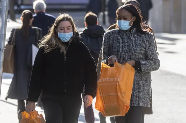 Two women wearing masks