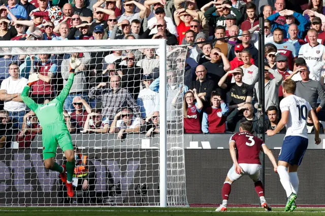 Lukasz Fabianski tips a Harry Kane header over the bar