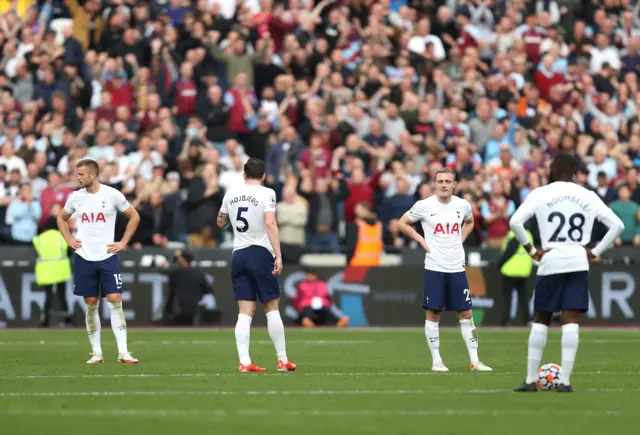 Tottenham players look on after conceding at West Ham