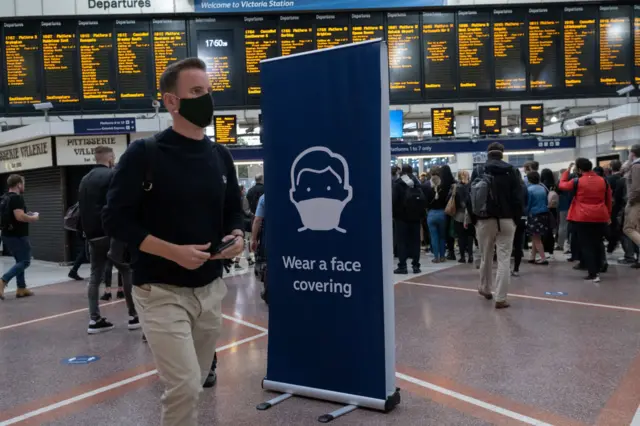 A rail passenger wearing a face mask