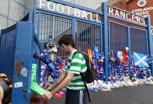 A Celtic supporter leaves a tribute to the late Walter Smith