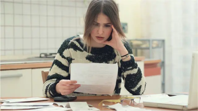 Woman reading bills