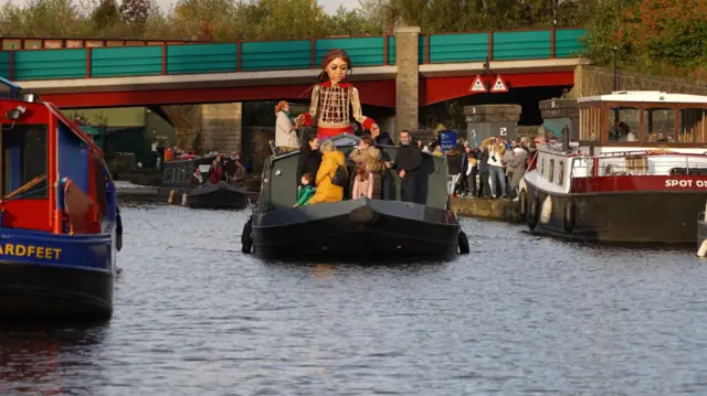 Little Amal arrives on a boat