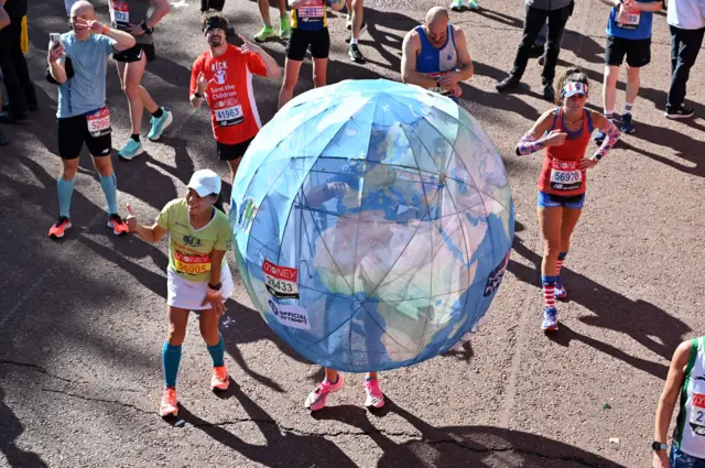 Runner wearing a globe costume