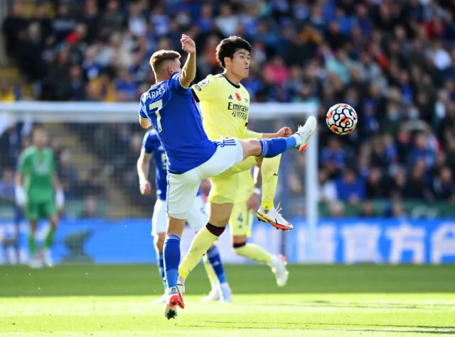 Harvey Barnes of Leicester City battles for possession with Takehiro Tomiyasu of Arsenal