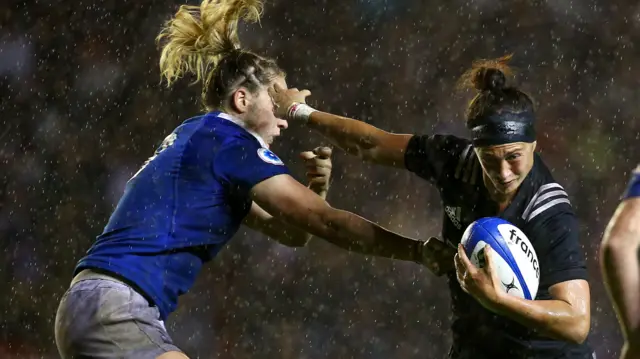 New Zealand's Les Elder hands off a France player