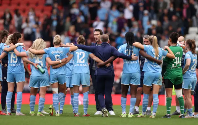 Manchester City boss Gareth Taylor speaks to his squad on the pitch