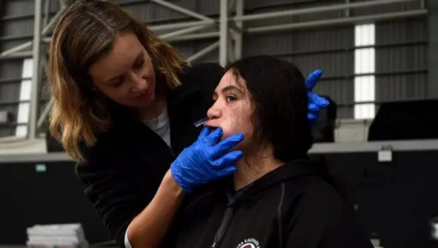 A player in New Zealand has a mouthguard fitted