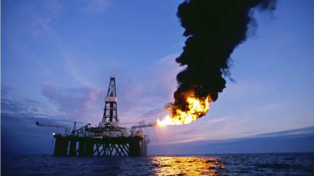 An offshore oil exploration rig, in the Scottish sector of the North Sea, burns off oil and natural gas it has just tapped