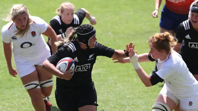 New Zealand's Eloise Blackwell hands off England's Cath O'Donnell