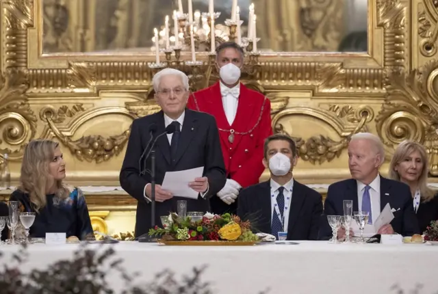 Sergio Mattarella (C) as he delivers a speech next to Dutch Queen Maxima (L) and US President joe Biden (R) during an official dinner