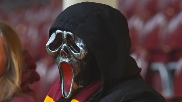 A Motherwell fan wearing a scream mask