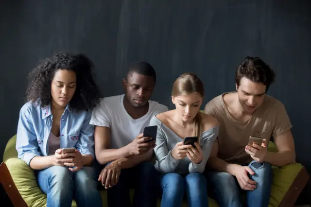 File photo of teens on phones