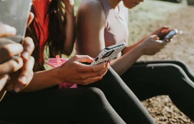 File photo of people on smartphones