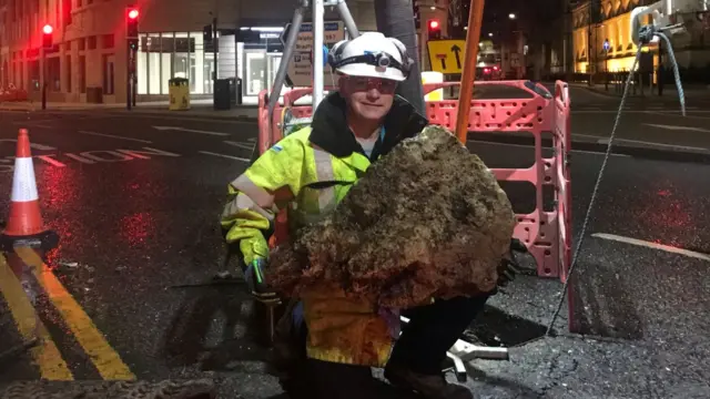 Man holding section of fatberg