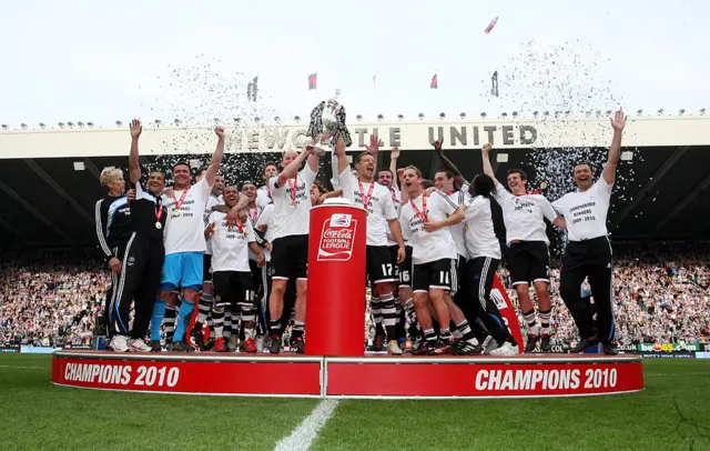 Newcastle players celebrate winning the trophy