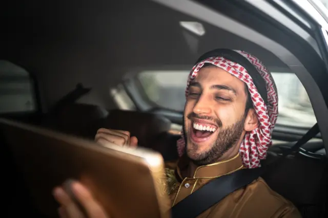 Arabic man watches sport on tablet