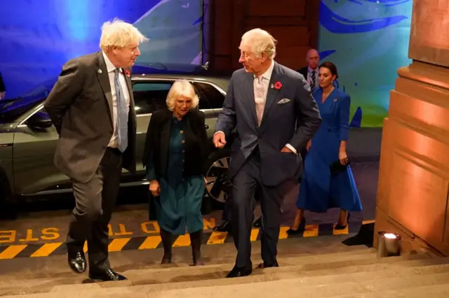 Prime Minister Boris Johnson greets Prince Charles as he arrives at the COP26 Summit