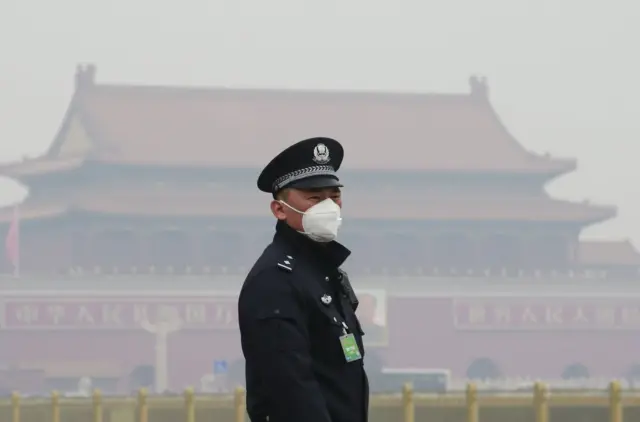 A Beijing traffic police officer in smog