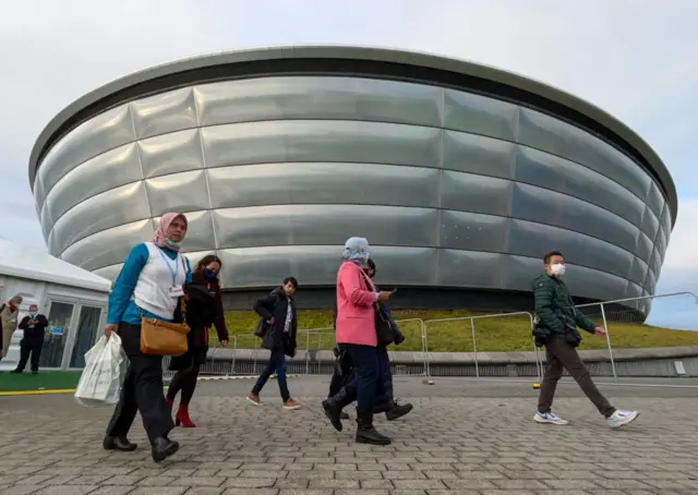 People walking past the SSE Hydro, part of the COP26 venue