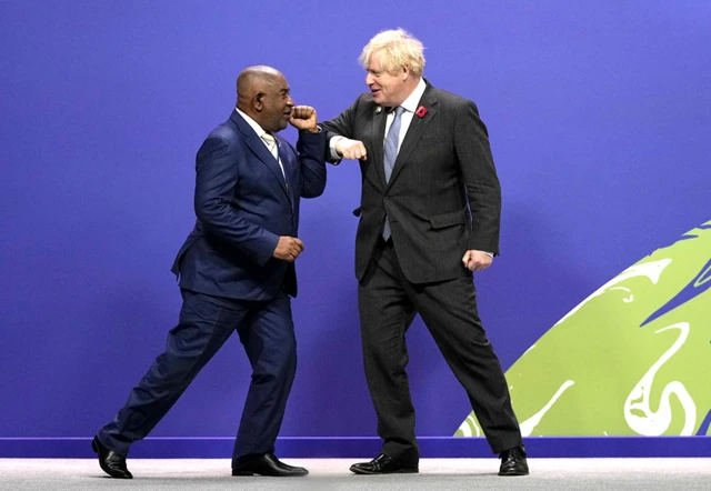 Boris Johnson greets Comoros' President Azali Assoumani at the Cop26 summit