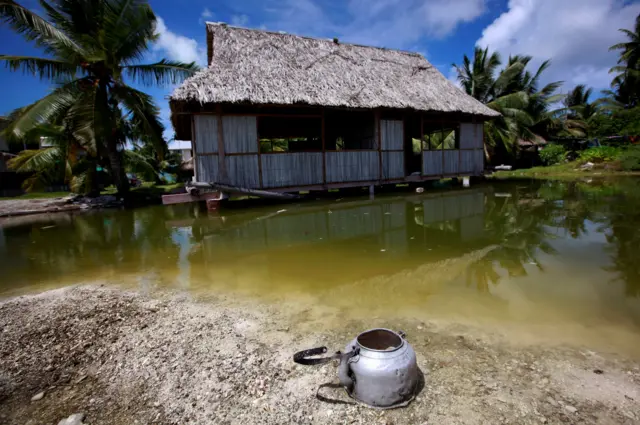 An abandoned house sinking under seawater in Kiribati