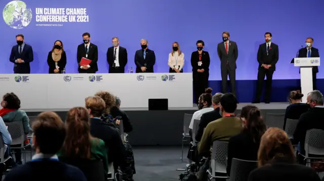 Ministers and representatives pose for a group picture during a meeting of the UN Climate Change Conference (COP26) in Glasgow, Scotland, Britain