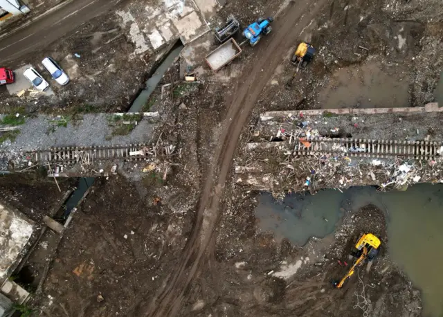An aerial view taken on August 19, 2021 shows a destroyed railway track during clearing work in Altenahr, Rhineland-Palatinate, western Germany, weeks after heavy rain and floods caused major damage in the Ahr region