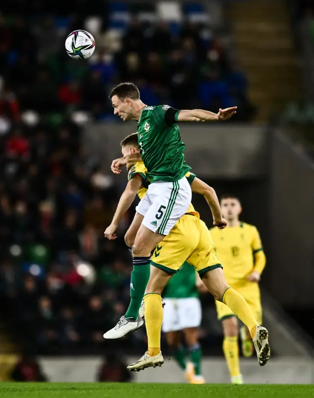 Jonny Evans of Northern Ireland in action against Karolis Laukemis of Lithuania