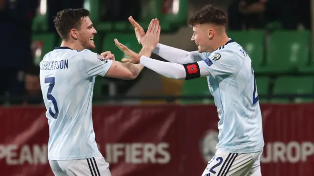 Patterson (right) celebrates with Scotland skipper Andy Robertson (left)