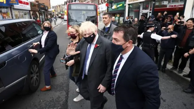 Boris Johnson leaves after visiting a coronavirus disease vaccination centre at a pharmacy in Sidcup, London