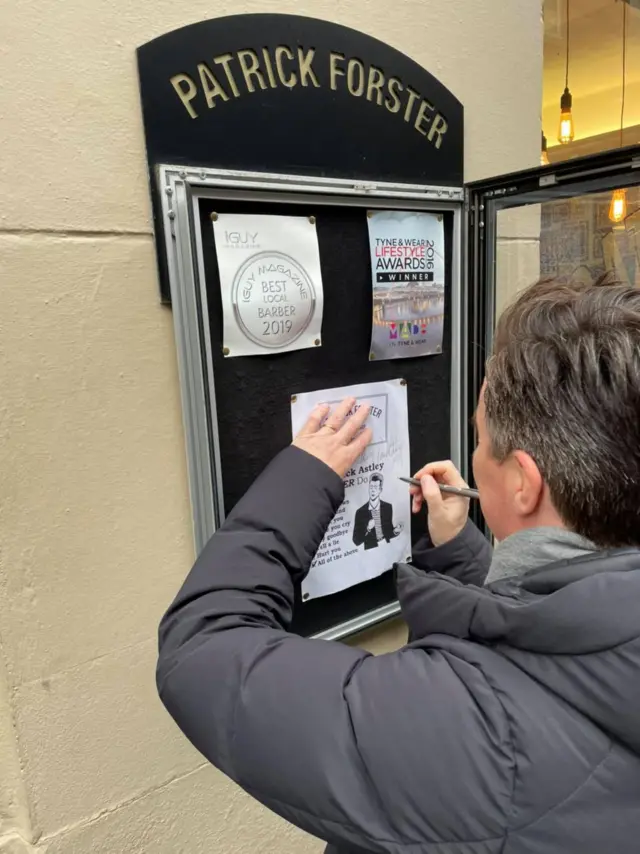 Rick Astley signing the poster