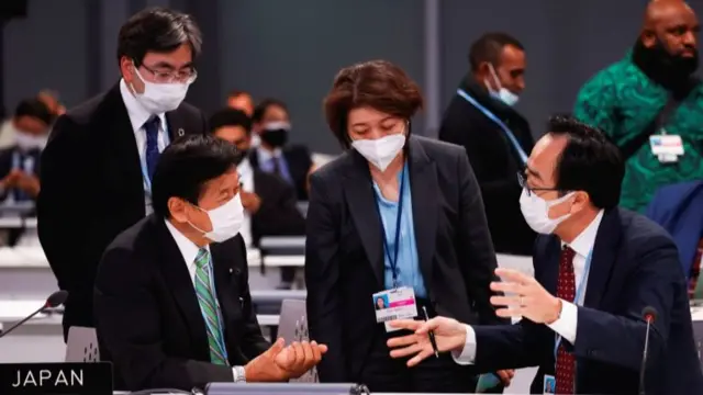 Japanese delegates huddle at the conference