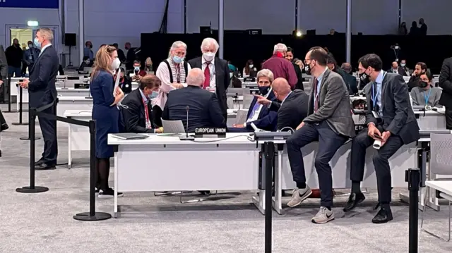 John Kerry speaking with delegates by the European Union desk