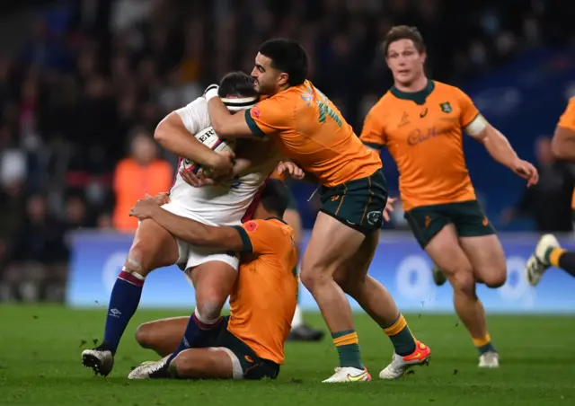 Jamie George is tackled high by Tom Wright