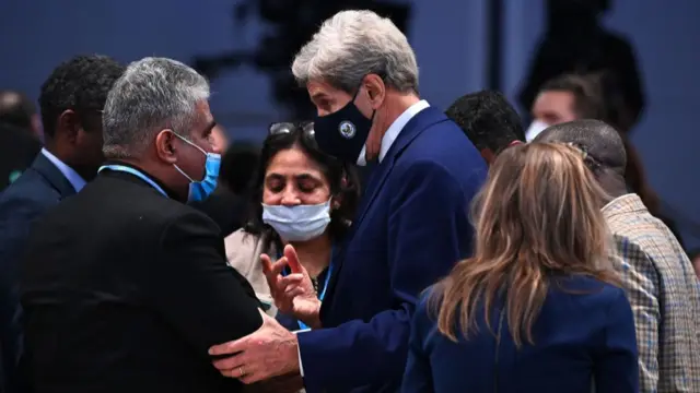 US climate envoy John Kerry squeezes the arm of his Indian counterpart