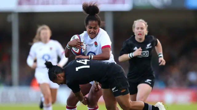 England's Lagi Tuima is tackled by New Zealand's Renee Wickliffe