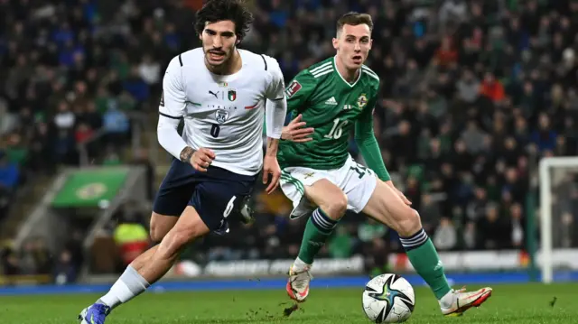 Sandro Tonali and Gavin Whyte battle for possession during the early stages of the game