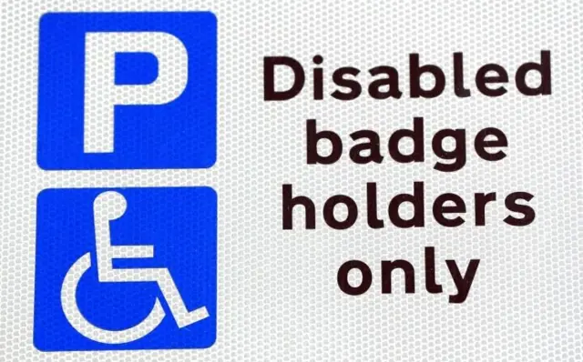 Disabled parking sign (Blue P / Wheelchair symbol - reads Diasbled badge holders only - At any time).