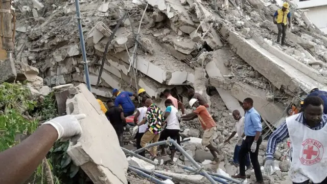 Rescue team goes through the rubble in collapsed building in search of survivors