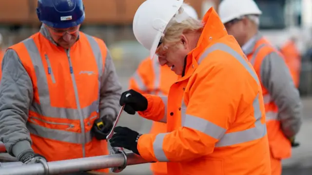 Boris Johnson using a spanner