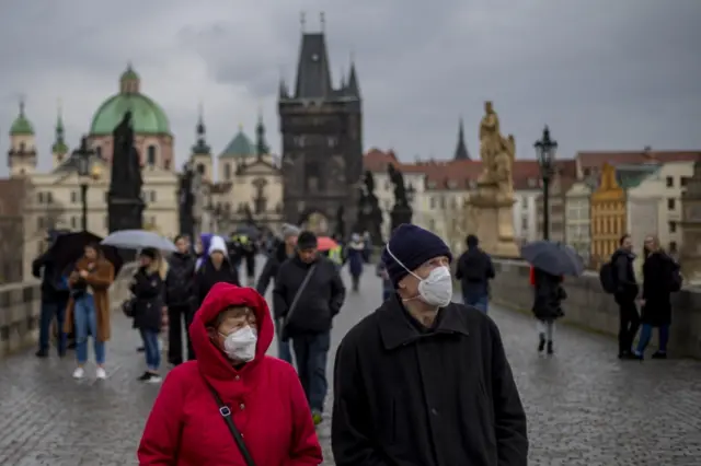 People on Charles Bridge, Prague, wearing masks