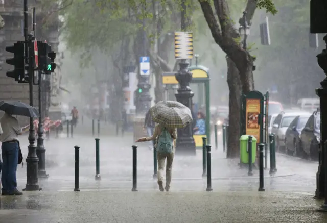 A woman walking through rain