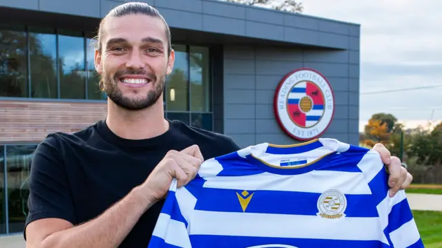 Andy Carroll poses with a Reading shirt