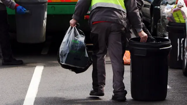 Workers carrying bins