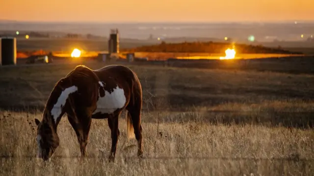 Flames from a flaring pit near a well in the Bakken Oil Field