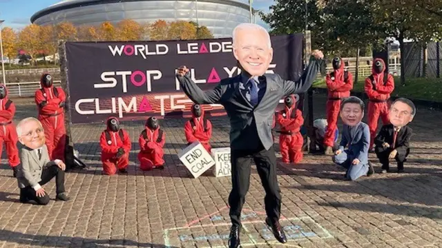 Squid Games protest including person in Biden mask