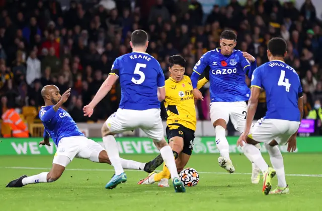 Hwang Hee-chan of Wolves is challenged by Everton's Fabian Delph and Ben Godfrey