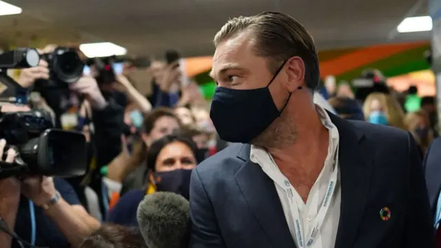 Leonardo DiCaprio surrounded by cameras at COP26